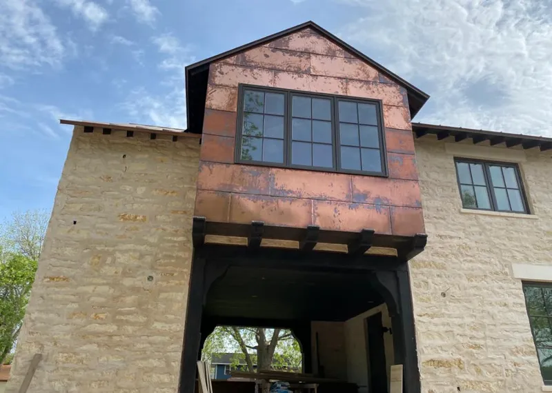 Copper metal panel facade on a stone building for Roof Repair in Glen Rock