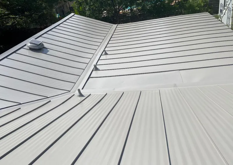 Solar attic fan installed on a metal roof for Roof Ventilation in Glen Rock