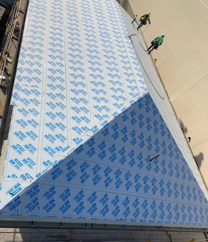 Professional roofers installing underlayment on a metal roof in Glen Rock